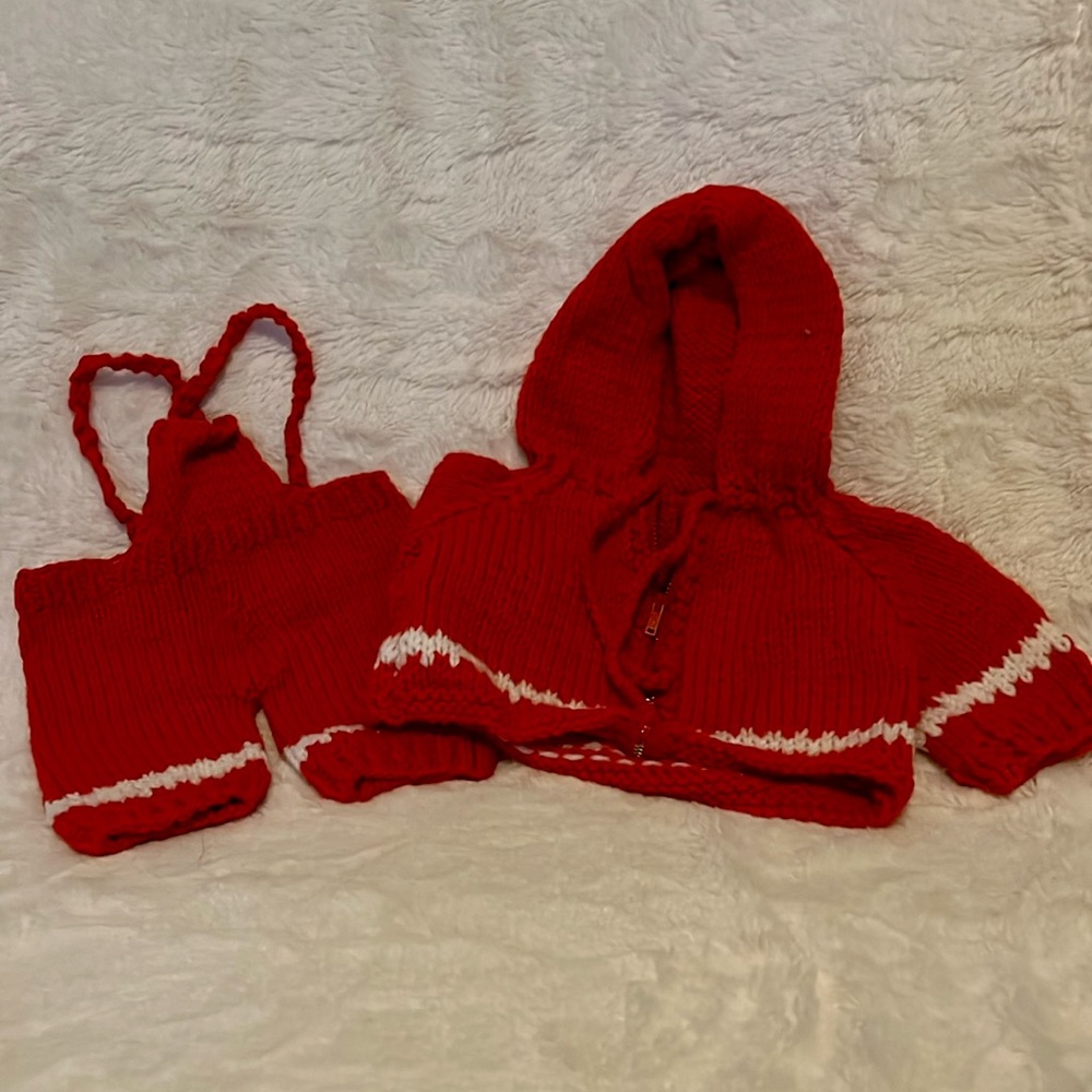 Red hand knitted doll clothes.